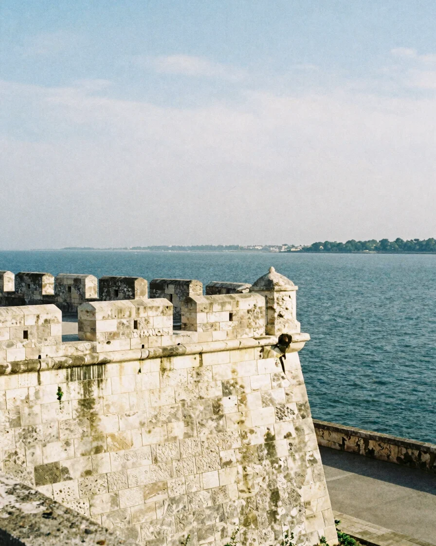 Wide-format editorial photograph of a sunlit stone fortification